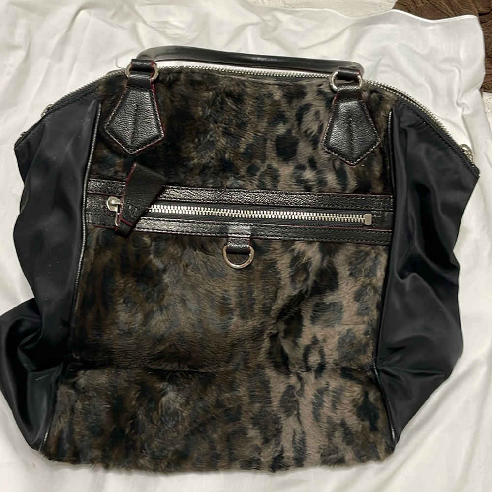 Leopard print with the feel of fur.MZ Wallace purse.Red trim with black handles.